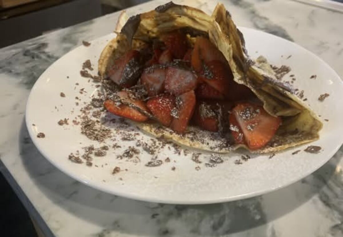 Strawberry and chocolate crêpe served with a cacao kiss smoothie on the marble counter