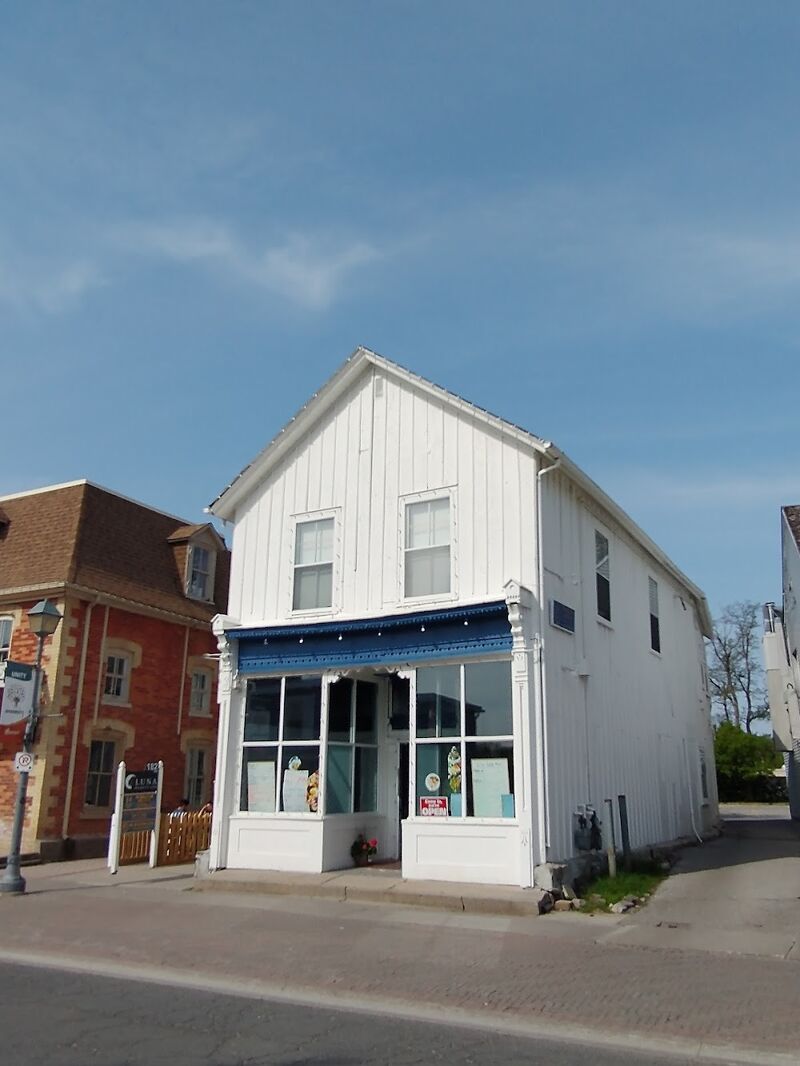 The white heritage building at 182 Main St Unionville seen from the corner on a clear day